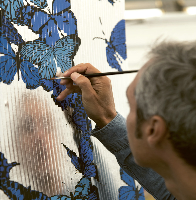 Patrick Rubinstein painting a work with blue butterflies